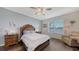 Spacious bedroom featuring hardwood floors, soft blue accent walls, and a decorative ceiling fan at 5910 Hevena Ct, Palmetto, FL 34221