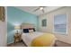 Bedroom with coastal design features, including a seahorse wall decor and blue accent wall at 5910 Hevena Ct, Palmetto, FL 34221