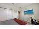 This bedroom features a large tv screen and closet with doors at 5910 Hevena Ct, Palmetto, FL 34221