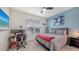 Comfortable bedroom with a large window, workspace, and entertainment options at 5910 Hevena Ct, Palmetto, FL 34221