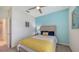 Bedroom featuring coastal decor and a comfortable bed with a ceiling fan at 5910 Hevena Ct, Palmetto, FL 34221