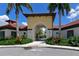 Welcoming entrance to the community clubhouse with lush landscaping and charming architectural details at 5910 Hevena Ct, Palmetto, FL 34221