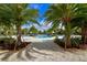 Relaxing community pool area surrounded by palm trees and comfortable lounge chairs at 5910 Hevena Ct, Palmetto, FL 34221