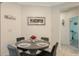 Cozy dining area with a modern table and seating for four near an entrance to a bedroom at 5910 Hevena Ct, Palmetto, FL 34221