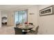 Dining area with modern table and chairs is situated next to glass doors accessing the lanai at 5910 Hevena Ct, Palmetto, FL 34221