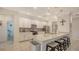 Beautiful kitchen featuring white cabinets, stainless steel appliances, and a large center island with seating at 5910 Hevena Ct, Palmetto, FL 34221