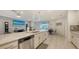Open-concept kitchen and living area with stainless steel appliances, breakfast bar, and plenty of natural light at 5910 Hevena Ct, Palmetto, FL 34221