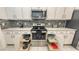 Updated kitchen features modern stainless steel appliances, tiled backsplash, and pull-out shelving at 5910 Hevena Ct, Palmetto, FL 34221