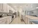 Modern kitchen with white cabinets, stainless steel appliances, and a large kitchen island at 5910 Hevena Ct, Palmetto, FL 34221