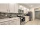 Well-equipped kitchen showcasing stainless steel appliances, light countertops, and a stylish backsplash at 5910 Hevena Ct, Palmetto, FL 34221