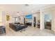 Bright living room with a sectional sofa and open access to other rooms in the home at 5910 Hevena Ct, Palmetto, FL 34221