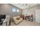 Inviting office space featuring neutral walls, tile flooring, and a cozy love seat for relaxing at 5910 Hevena Ct, Palmetto, FL 34221