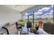 Enclosed patio featuring a view of the lake, with chairs and patio furniture at 5910 Hevena Ct, Palmetto, FL 34221