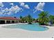 Community pool offers sun loungers and pristine blue water for relaxation, next to the clubhouse at 5910 Hevena Ct, Palmetto, FL 34221