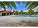 Exterior view of a community pool with a covered lounge area and palm trees at 5910 Hevena Ct, Palmetto, FL 34221