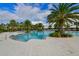 Large community pool with palm trees and lounge areas, perfect for relaxation and recreation at 5910 Hevena Ct, Palmetto, FL 34221
