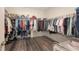 Large walk-in closet with ample storage space and wooden flooring at 5910 Hevena Ct, Palmetto, FL 34221