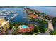 Waterfront living, showcasing a private pool, lush landscaping, boat docks, and waterfront homes at 610 Riviera Dunes Way # 306, Palmetto, FL 34221