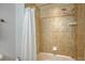 Tiled shower with adjustable shower head and helpful soap dish at 610 Riviera Dunes Way # 306, Palmetto, FL 34221