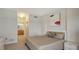 Neutral bedroom featuring carpet floors and an adjoining bathroom with wood cabinets at 610 Riviera Dunes Way # 306, Palmetto, FL 34221