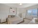 Well-lit bedroom with water view, neutral colors, and contemporary furniture at 610 Riviera Dunes Way # 306, Palmetto, FL 34221