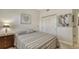Inviting bedroom with a charming lamp, zebra art, and ample closet space at 610 Riviera Dunes Way # 306, Palmetto, FL 34221
