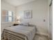 Cozy bedroom features a comfortable bed, shuttered windows, and neutral decor at 610 Riviera Dunes Way # 306, Palmetto, FL 34221
