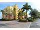 Beautiful condo building with well-manicured landscaping and a convenient parking area for residents and guests at 610 Riviera Dunes Way # 306, Palmetto, FL 34221