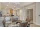 Elegant dining room with a glass table, seating for four, and an open view to the kitchen at 610 Riviera Dunes Way # 306, Palmetto, FL 34221