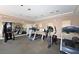 Community gym fully equipped with various workout machines and mirrors in a well lit room with carpet at 610 Riviera Dunes Way # 306, Palmetto, FL 34221