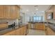 Spacious kitchen featuring stainless steel appliances, granite counters, and access to the living room at 610 Riviera Dunes Way # 306, Palmetto, FL 34221