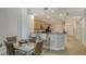 Open-concept kitchen with breakfast bar, stainless steel appliances, and adjacent dining area at 610 Riviera Dunes Way # 306, Palmetto, FL 34221