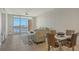 Bright living room featuring tile floors, neutral colors, and sliding doors to a balcony with water views at 610 Riviera Dunes Way # 306, Palmetto, FL 34221