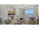 Bright living room featuring a waterfront view, a sleek entertainment center, and a calming interior design at 610 Riviera Dunes Way # 306, Palmetto, FL 34221