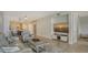 Inviting living room with open-concept design, modern furnishings, and serene beach view on the television at 610 Riviera Dunes Way # 306, Palmetto, FL 34221