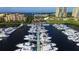 A luxurious waterfront marina featuring numerous boats docked along piers with buildings and a restaurant in the background at 610 Riviera Dunes Way # 306, Palmetto, FL 34221