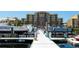 Beautiful waterfront condo and marina view with boats docked on a sunny day at 610 Riviera Dunes Way # 306, Palmetto, FL 34221