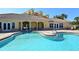 A refreshing community pool with tiled roof buildings and many places to relax and enjoy the outdoors at 610 Riviera Dunes Way # 306, Palmetto, FL 34221