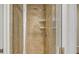 Tiled shower with glass door and built-in shelves for added convenience at 610 Riviera Dunes Way # 306, Palmetto, FL 34221