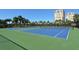 Outdoor tennis courts surrounded by lush landscaping providing a great place to play tennis and be active at 610 Riviera Dunes Way # 306, Palmetto, FL 34221