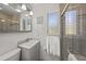 Well-lit bathroom featuring a vanity, a mirrored cabinet, and a glass-enclosed shower at 627 Avenida Del Norte, Sarasota, FL 34242