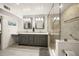 Bathroom featuring double sinks, granite countertops, modern fixtures, and a glass-enclosed shower at 627 Avenida Del Norte, Sarasota, FL 34242