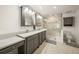 Bathroom showcasing double sinks, granite countertops, modern fixtures, and a glass-enclosed shower with a seat at 627 Avenida Del Norte, Sarasota, FL 34242