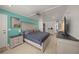 Bright bedroom featuring light colored wood floors, a ceiling fan, and large flat screen tv at 627 Avenida Del Norte, Sarasota, FL 34242