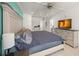 Bright bedroom with light wood floors, large bed, and view of a bathroom at 627 Avenida Del Norte, Sarasota, FL 34242