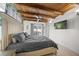 Bedroom with wood-beam ceiling, tv, and view of the pool through glass doors at 627 Avenida Del Norte, Sarasota, FL 34242