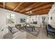 Living room with beamed ceiling, white sofas, and large windows, creating a bright, cozy space at 627 Avenida Del Norte, Sarasota, FL 34242
