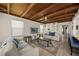 Well-lit living room with wood-beamed ceiling, white couches, and tile floors for a coastal feel at 627 Avenida Del Norte, Sarasota, FL 34242