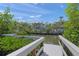 A lovely view of a canal, with a dock and beautiful landscaping at this home at 627 Avenida Del Norte, Sarasota, FL 34242