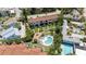 Aerial view of condo community featuring well-manicured grounds and a sparkling pool at 6840 Midnight Pass Rd # 6840, Sarasota, FL 34242